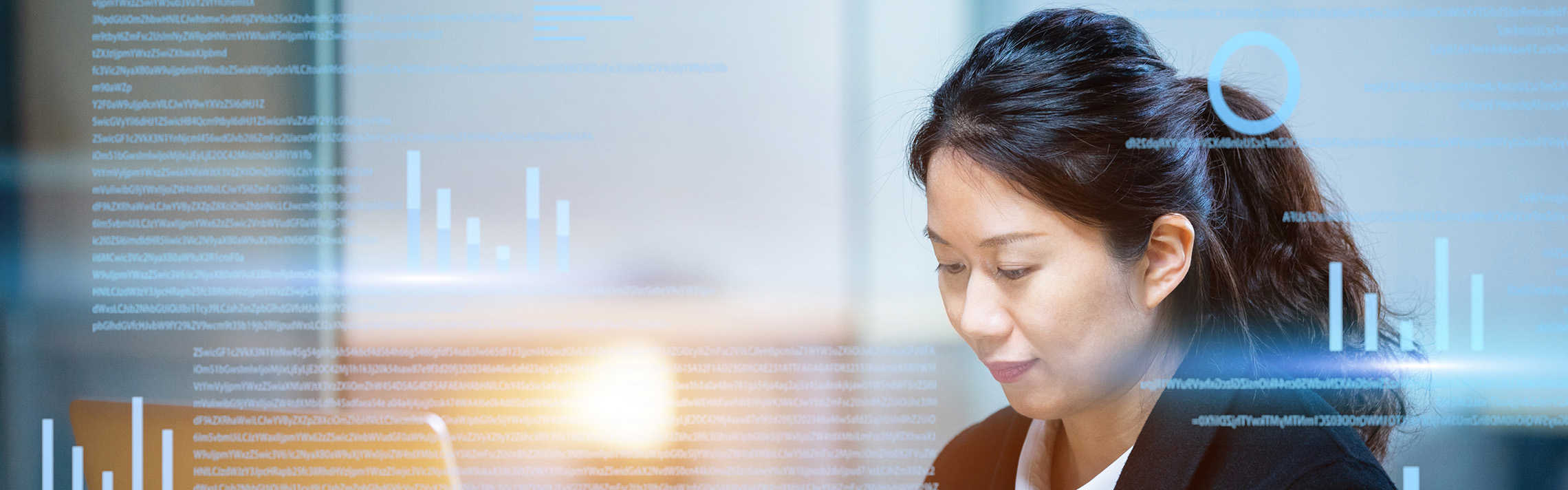 Woman looking at laptop with graphs.